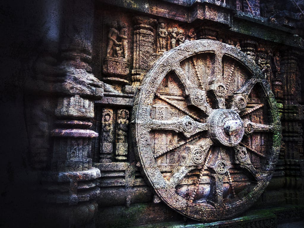Home Intricate stone carving of a chariot wheel at the historic Konark Sun Temple, India.